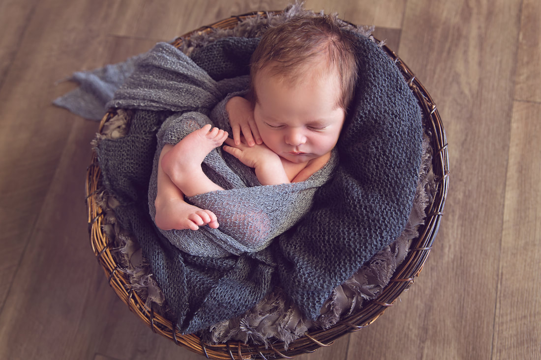 Tiny Feet Photography Newborn baby boy in brown basket with black fluff