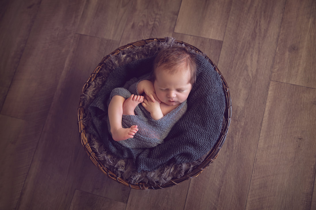 Tiny Feet Photography Newborn Baby boy in basket on black and grey fluff