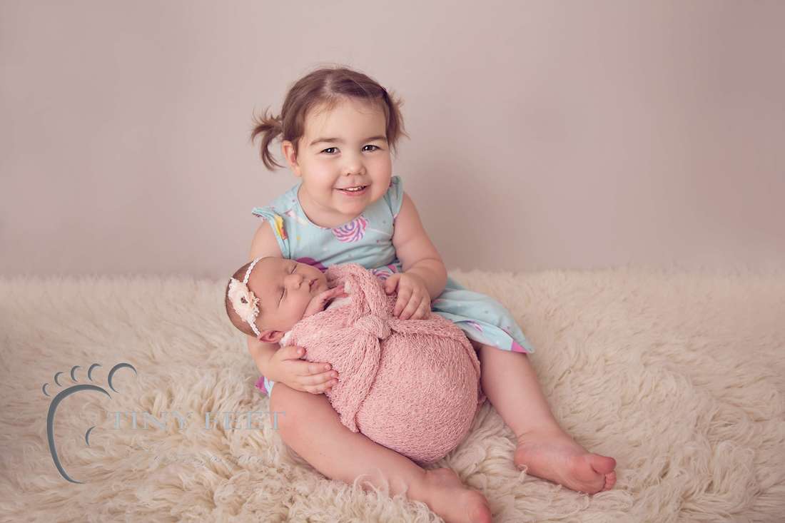 Tiny Feet photography newborn baby girl posed with sibling