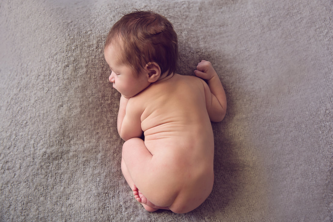Tiny Feet Photography Newborn baby boy posed on grey fluff backdrop