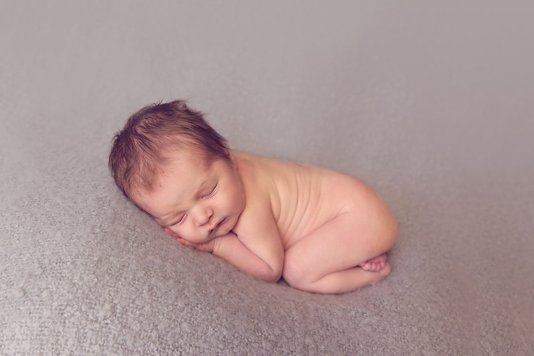 Tiny Feet Photography Newborn baby boy on grey posing blanket in bum up pose
