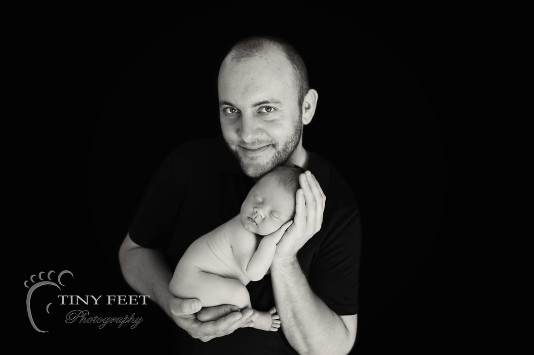 Tiny Feet Photography black and white shot of baby in dads arms
