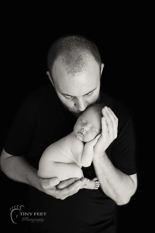 Tiny Feet Photography black and white shot of baby in dads arms
