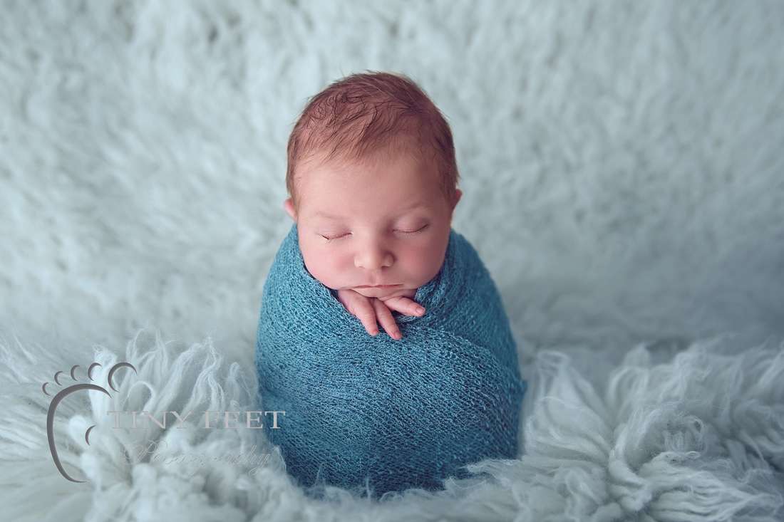Tiny Feet Photography baby boy wrapped in green wrap in potato sack pose