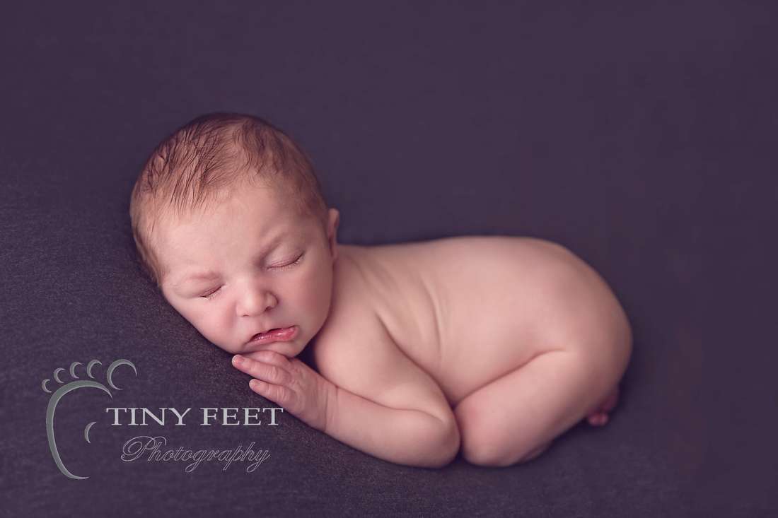 Tiny Feet Photography baby boy posed on grey blanket on tummy