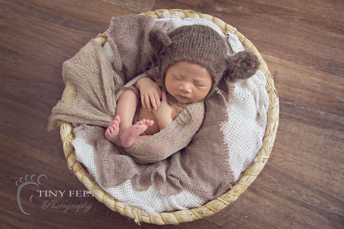 Tiny Feet Photography Newborn baby boy posed in basket