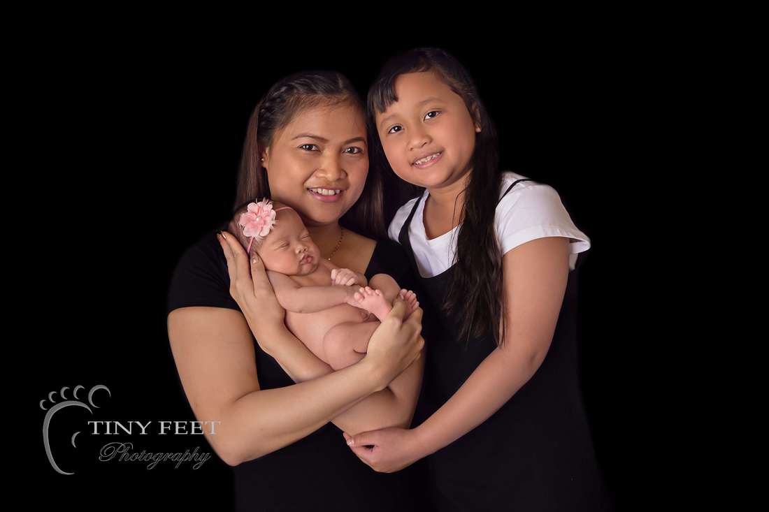 Tiny Feet Photography newborn baby girl  posed with mum and sibling