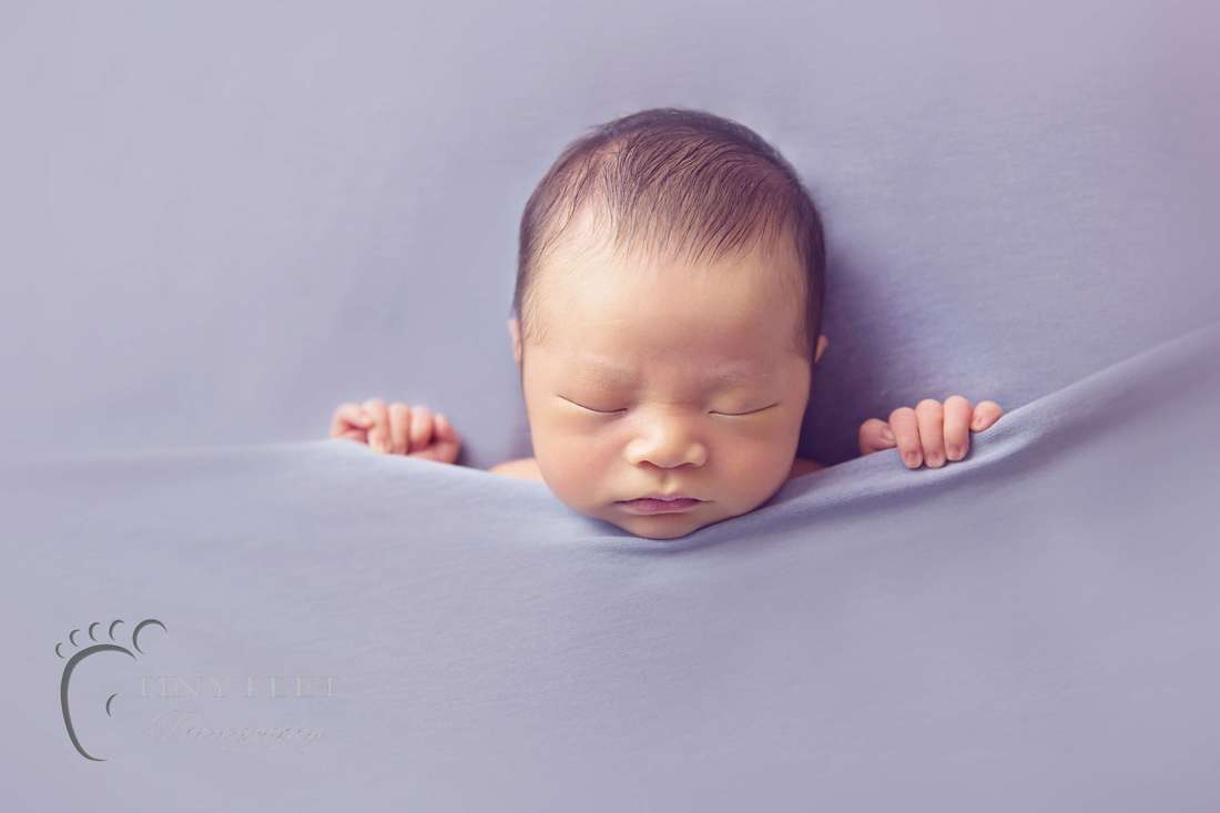 Tiny Feet Photography Newborn tucked in pose on beanbag