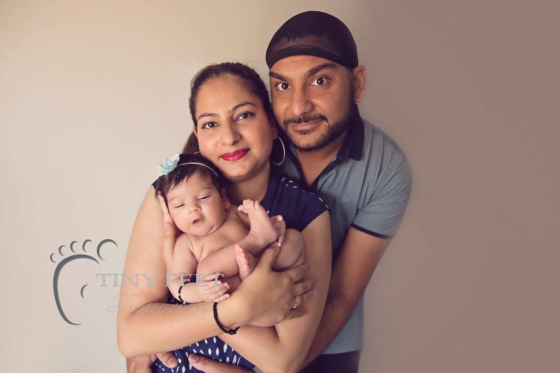 Tiny Feet Photography newborn baby girl posed with parents