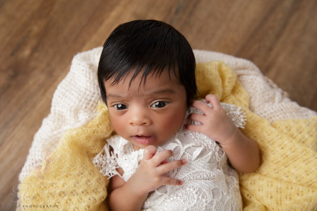 Tiny Feet Photography Newborn girl in yellow fabric wide awake 