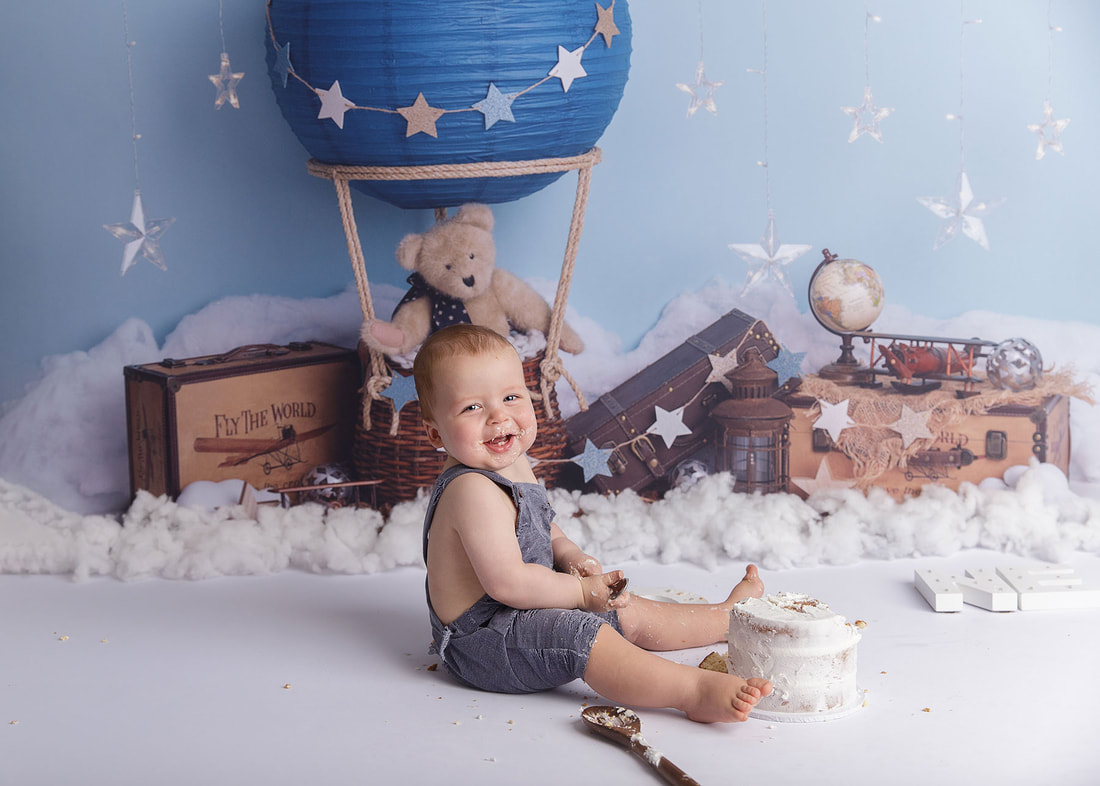 first birthday staged photograph with Mickey Mouse decorations