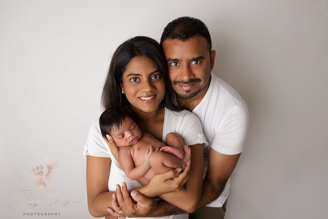 Tiny Feet Photography Newborn girl posed with parents 