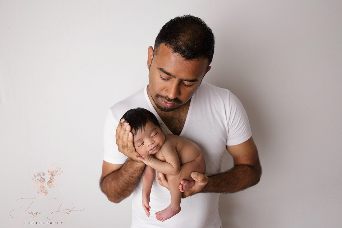 Tiny Feet Photography Newborn girl posed with daddy