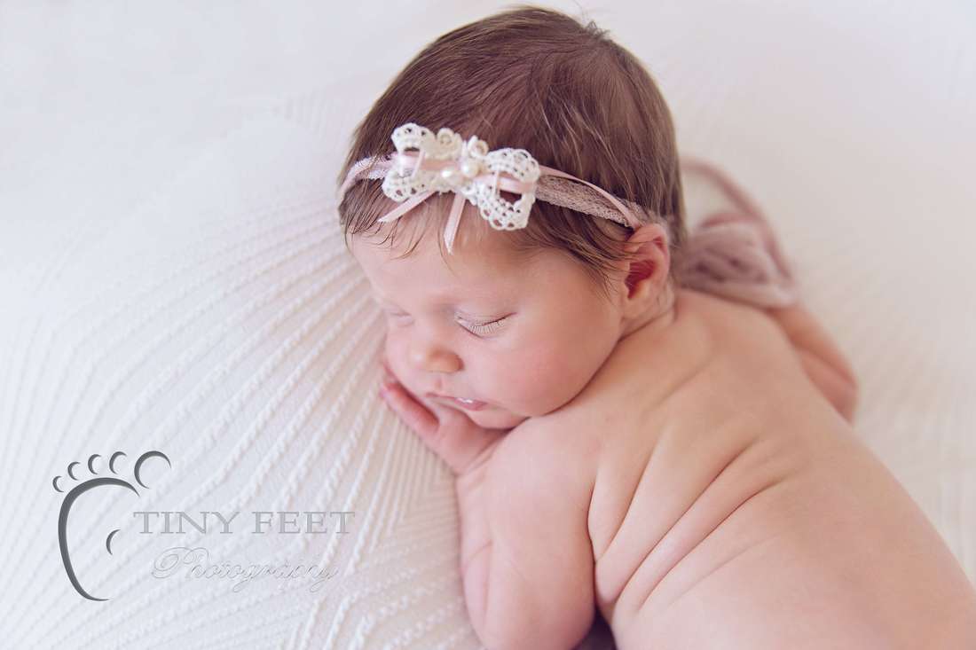 Tiny Feet Photography baby girl posed on white blanket on beanbag