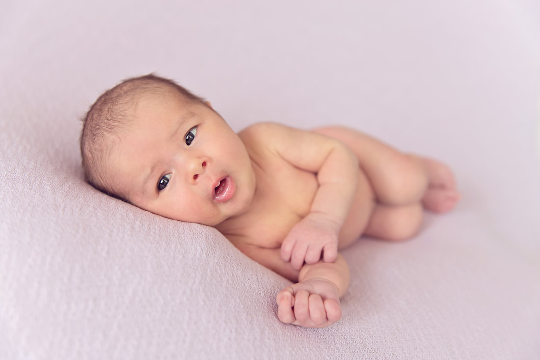 Tiny Feet Photography Newborn Awake side posing on beanbag baby girl