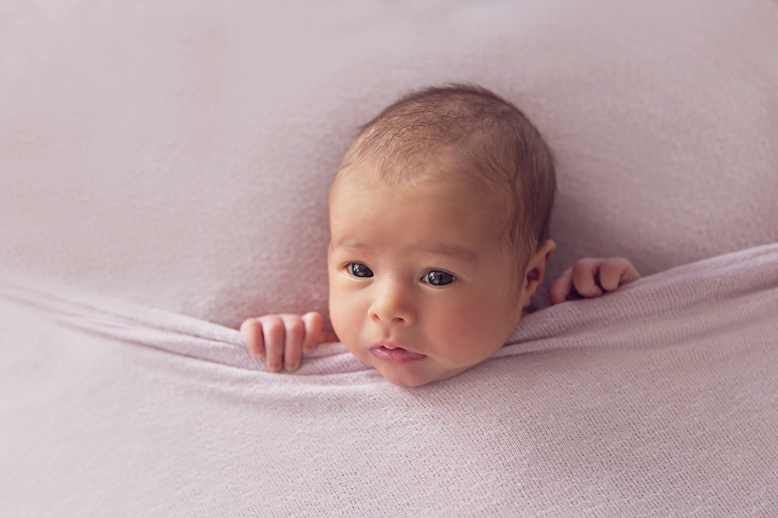 Tiny Feet Photography Newborn baby girl tucked in pose awake on beanbag
