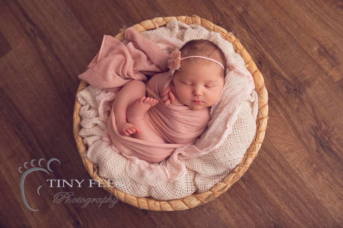 Tiny Feet Photography Perth newborn girl posed in round basket in pink wrap