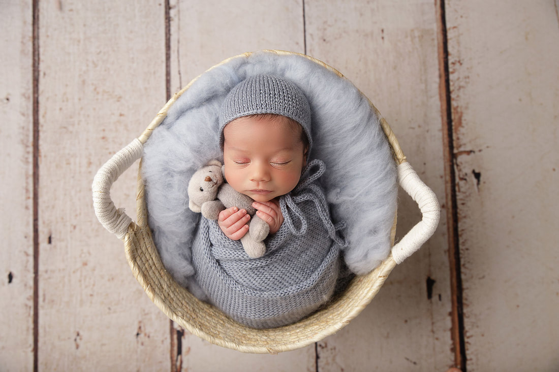 Posed newborn baby in a basket