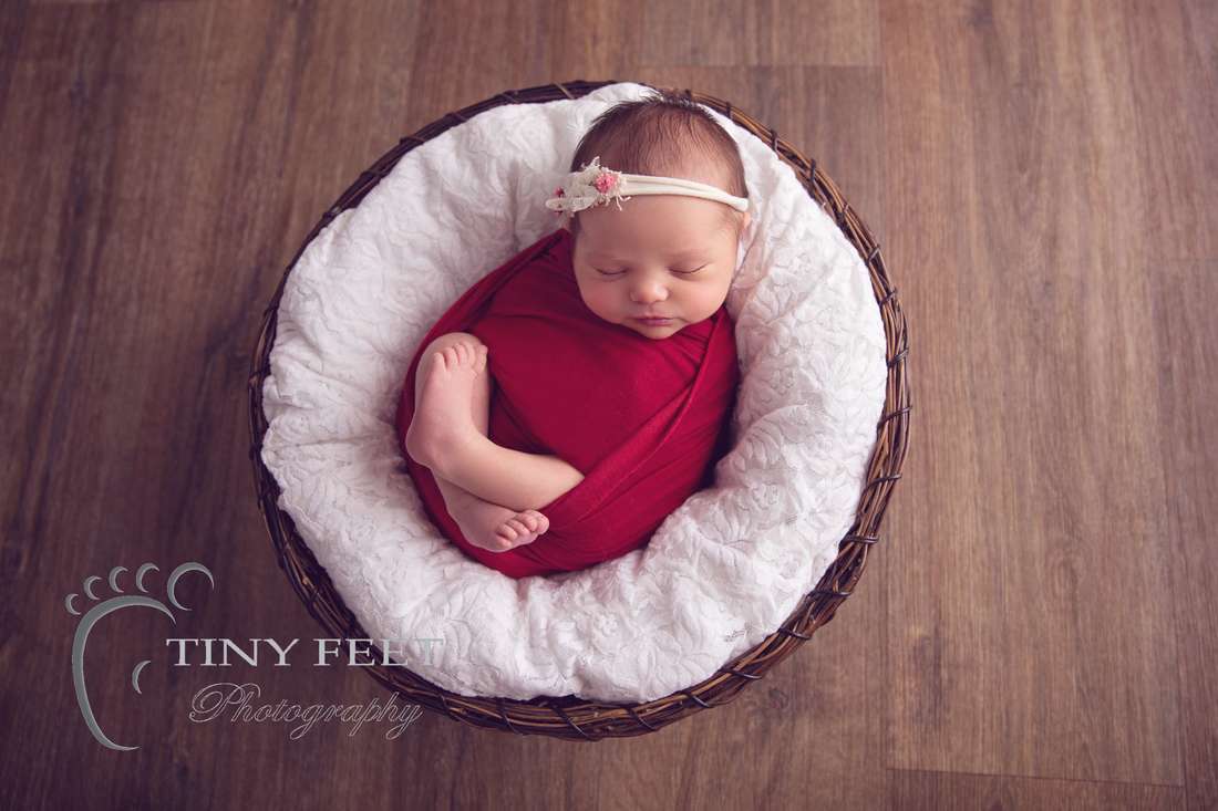 Tiny Feet Photography baby girl wrapped in red on white lace