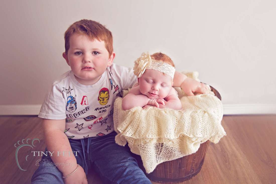 Tiny Feet Photography Newborn baby posed with 3 year old sibling in bucket