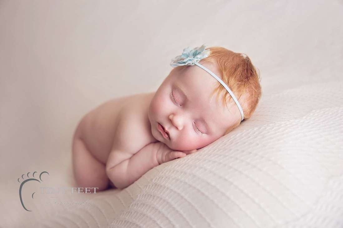 Tiny Feet Photography newborn baby girl posed on white bean bag blanket in bum up