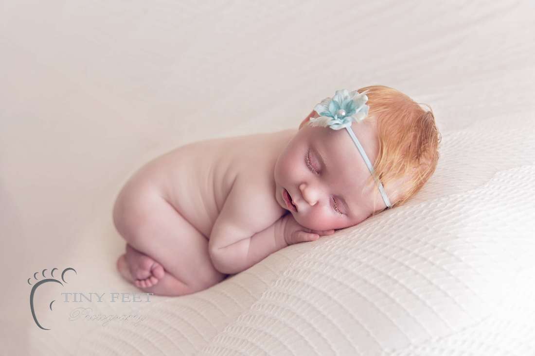 Tiny Feet Photography newborn baby posed on white beanbag blanket in bum up