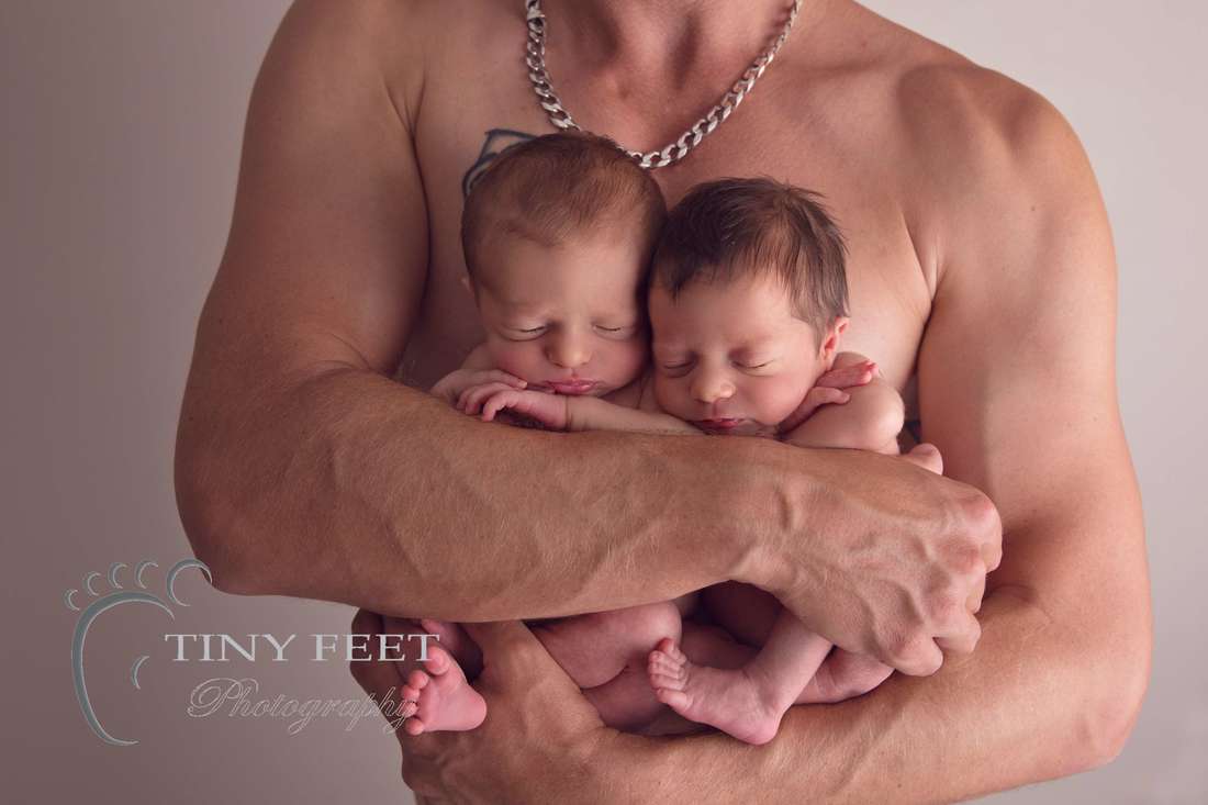 Tiny Feet Photography newborn twin posed in dads arms