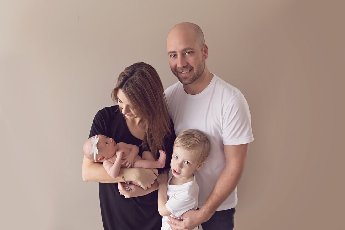 Tiny Feet Photography Newborn baby posing with family