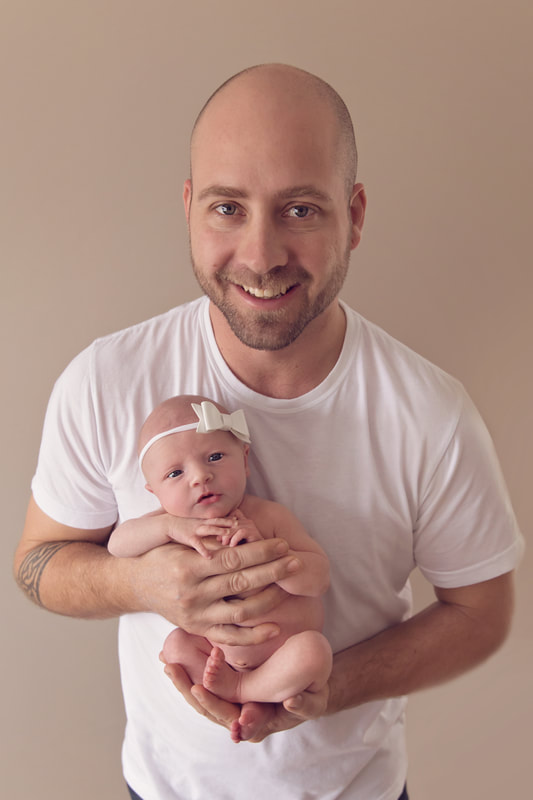Tiny Feet Photography Newborn baby posing with dad