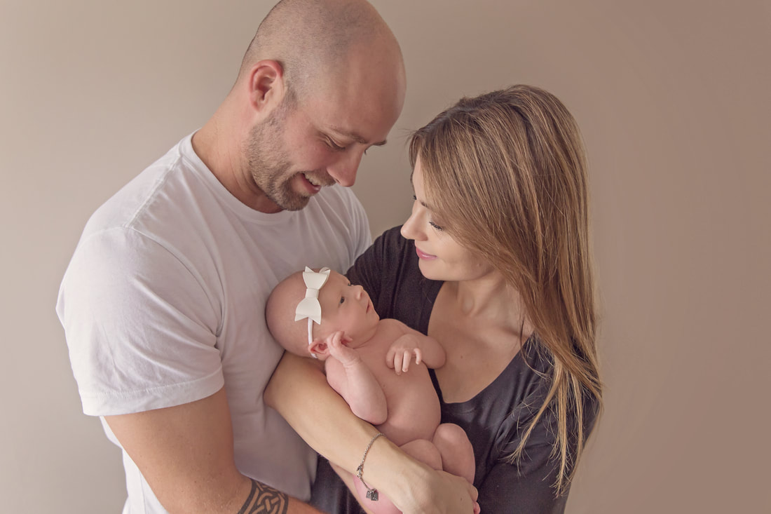 Tiny Feet Photography Newborn baby posing with family