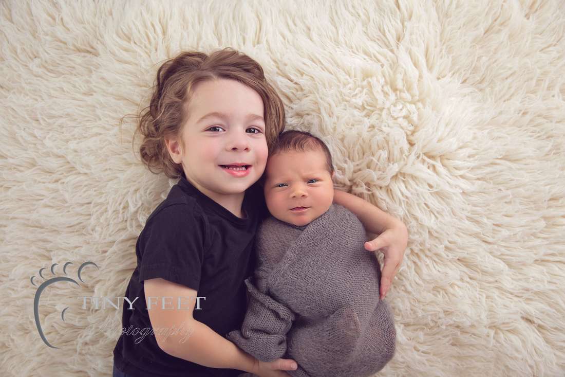 Tiny Feet Photography Newborn baby boy posed with sibling