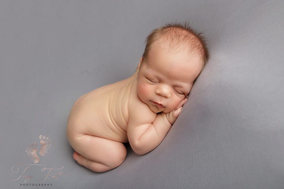 Tiny Feet Photography Newborn baby boy posed on bum up pose on tummy on beanbag