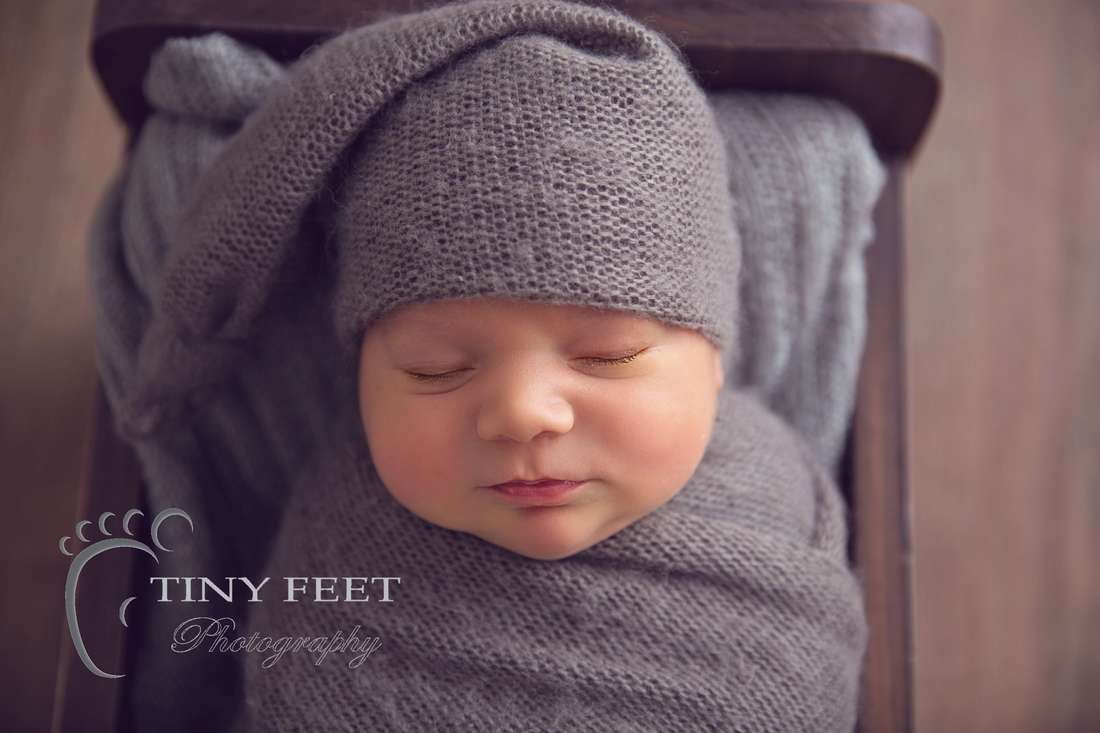 Tiny Feet Photography newborn baby boy wrapped and posed in Little Jar Big dreams wooden bed