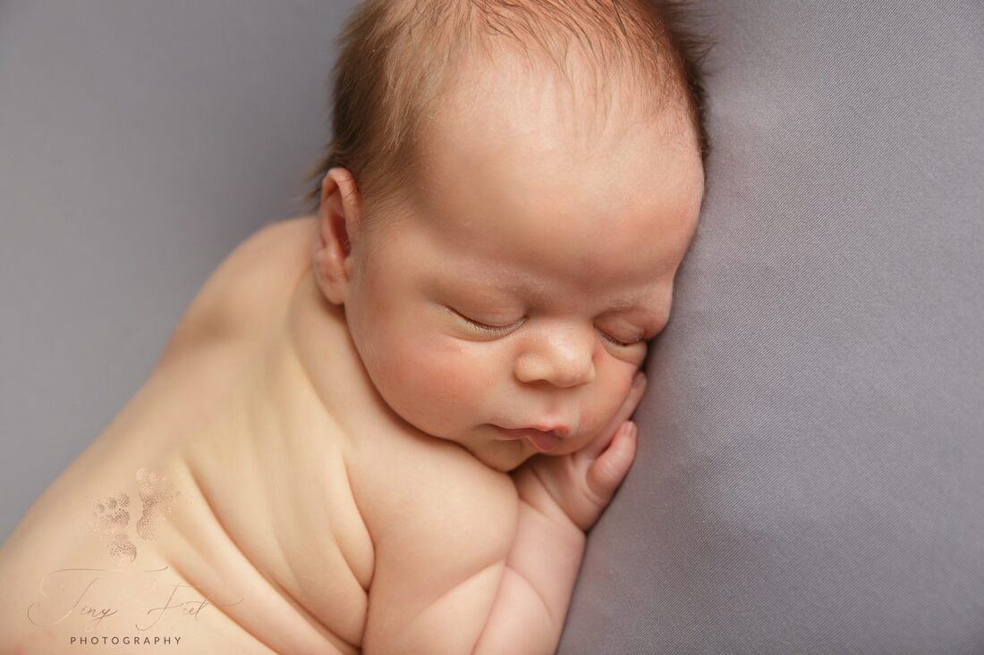 Tiny Feet Photography Newborn baby boy posed on bum up pose on tummy on beanbag