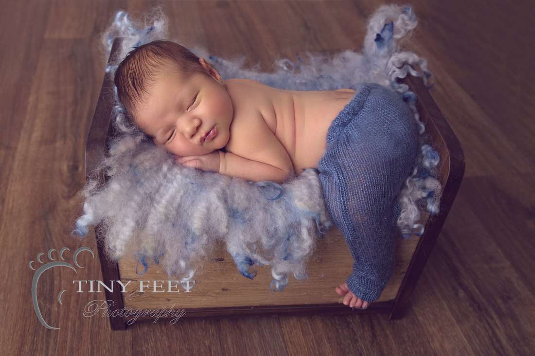 Tiny Feet Photography newborn baby boy posed on Little Jar Big Dreams wooden bed
