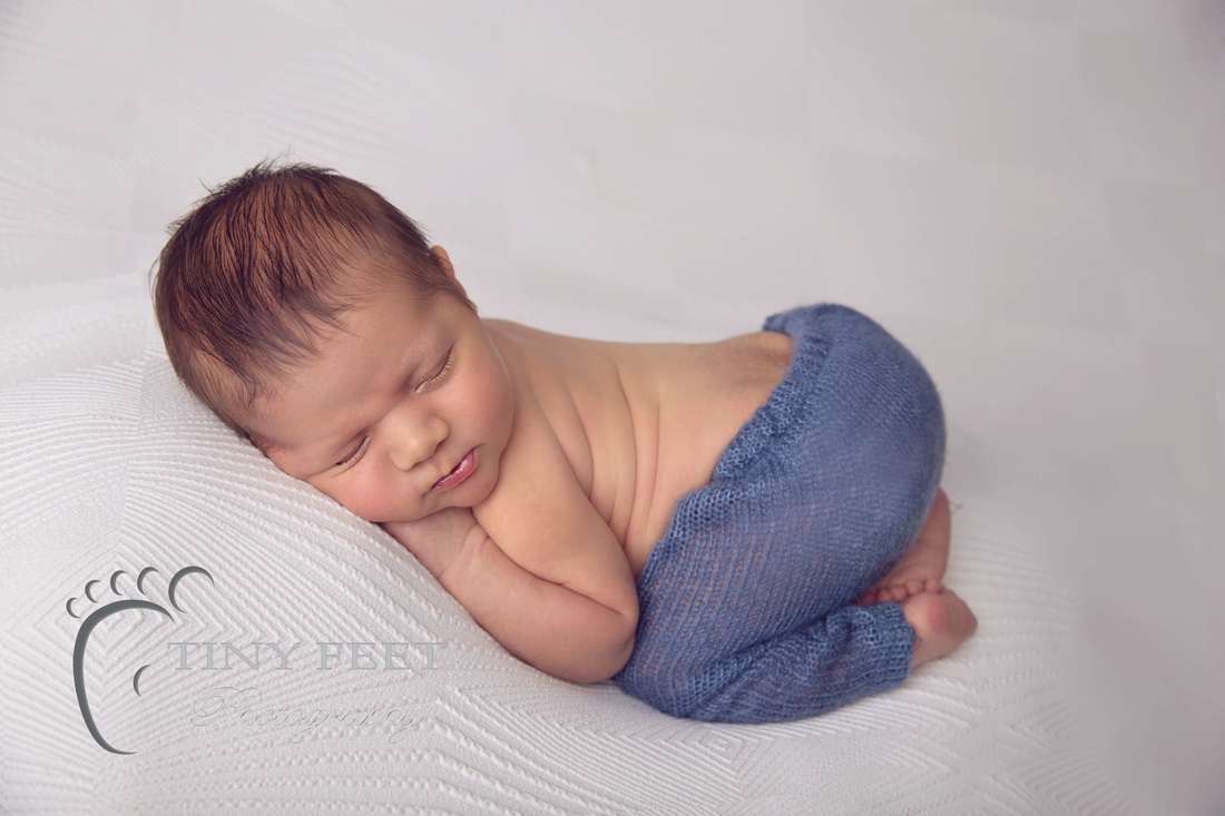 Tiny Feet Photography newborn baby boy posed in bum up pose on white blanket