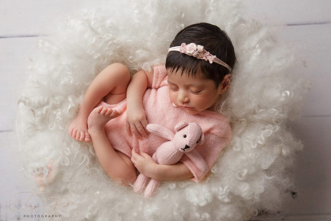 Tiny Feet Photography image of a sweet baby girl in pink outfit with pink teddy photographed in white curly fluffy layer
