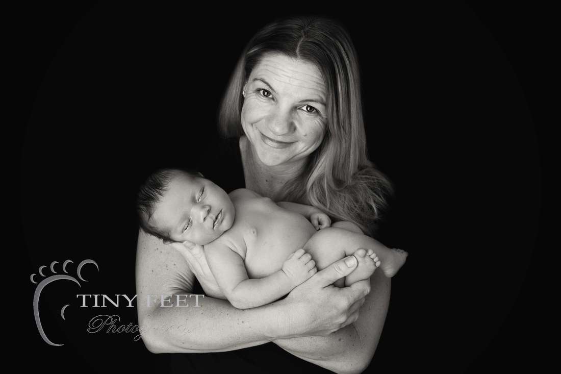 Tiny Feet Photography black and white image of newborn baby boy posed with mum