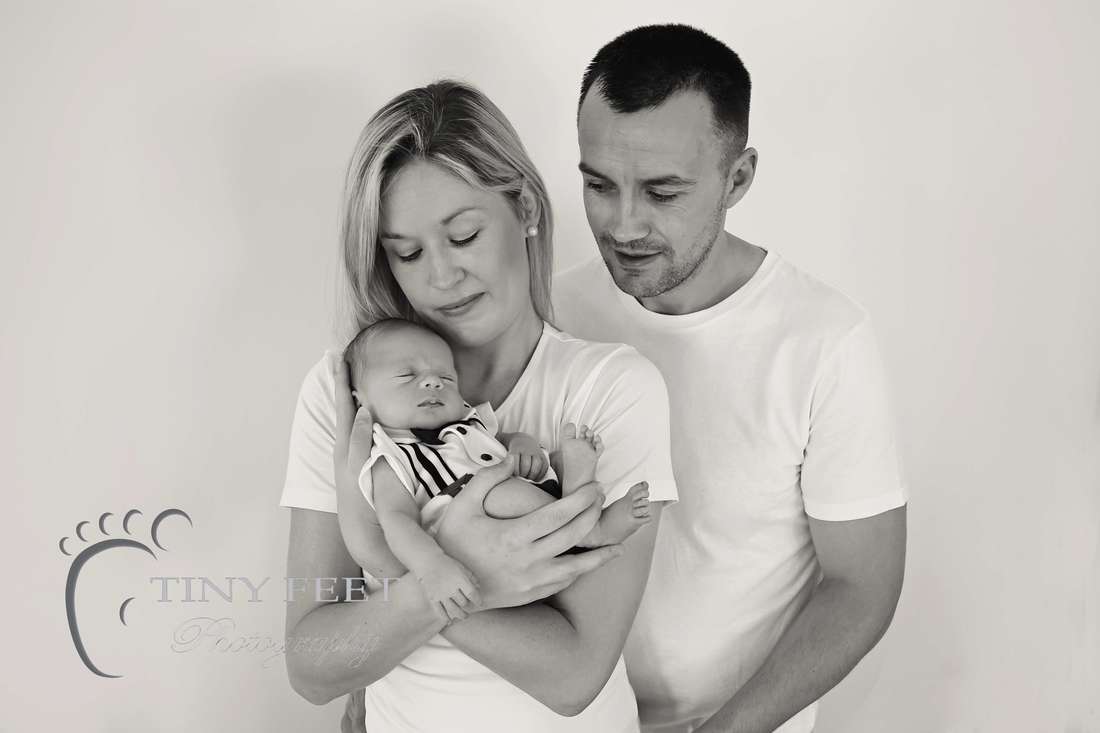 Tiny Feet Photography Newborn baby boy Black and white posed shot with parents 