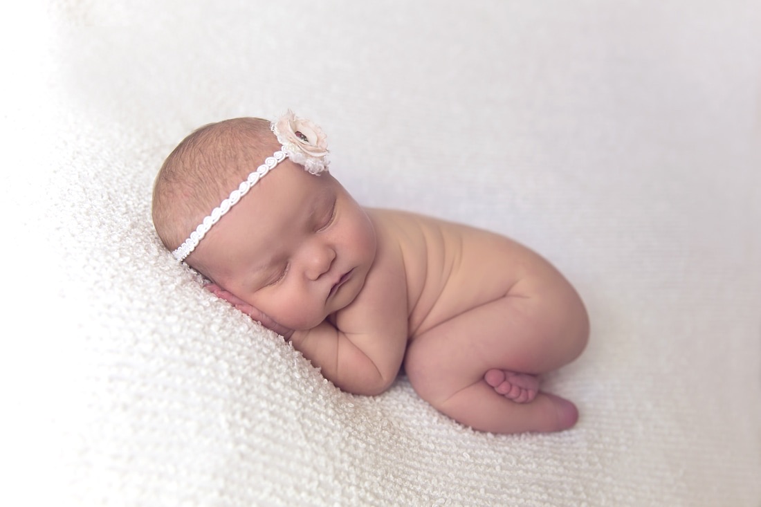 Tiny Feet Photography Baby girl newborn posing on white blanket bum up pose